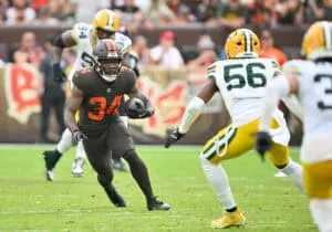 CLEVELAND, OHIO - SEPTEMBER 21: Jerome Ford #34 of the Cleveland Browns runs the ball against Edgerrin Cooper #56 of the Green Bay Packers at Huntington Bank Field on September 21, 2025 in Cleveland, Ohio.