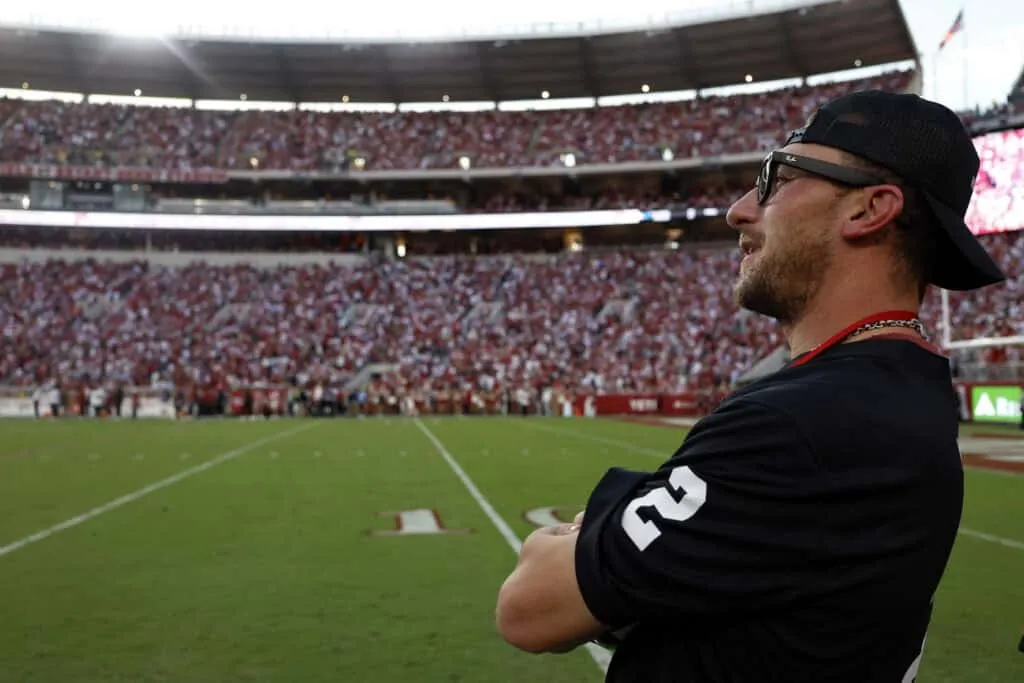 TUSCALOOSA, ALABAMA - OCTOBER 04: Former college and pro football player Johnny Manziel watches the fourth quarter of the game between the Alabama Crimson Tide and the Vanderbilt Commodores at Bryant-Denny Stadium on October 4, 2025 in Tuscaloosa, Alabama.