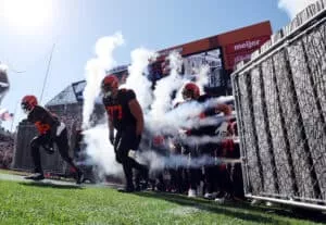 Wyatt Teller #77 of the Cleveland Browns runs on to the field with teammates prior to the game against the Los Angeles Chargers at FirstEnergy Stadium on October 09, 2022 in Cleveland, Ohio.