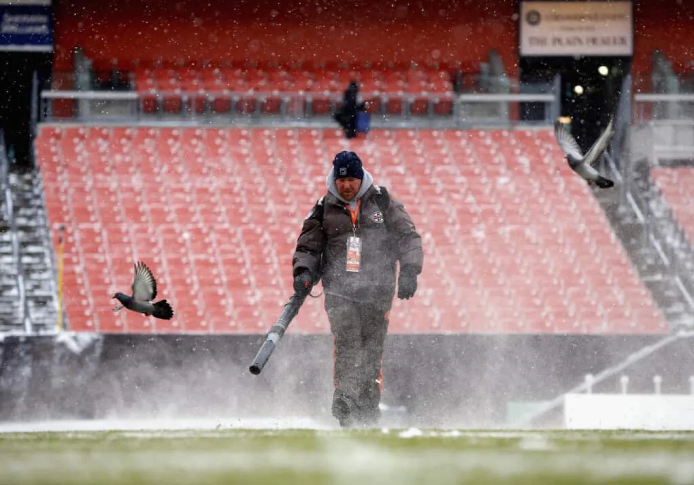 CLEVELAND, OH - DECEMBER 15: An employee cleans snow from the field at FirstEnergy Stadium before the Cleveland Browns host the Chicago Bears on December 15, 2013 in Cleveland, Ohio.