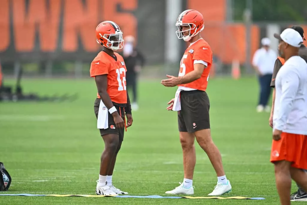 BEREA, OHIO - JUNE 12: Quarterback Shedeur Sanders #12 listens to quarterback Joe Flacco #15 of the Cleveland Browns during organized team activities at CrossCountry Mortgage Campus on June 12, 2025, in Berea, Ohio.
