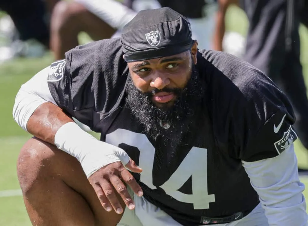 HENDERSON, NEVADA - MAY 29: Defensive tackle Christian Wilkins #94 of the Las Vegas Raiders stretches during an OTA offseason workout at the Las Vegas Raiders Headquarters/Intermountain Healthcare Performance Center on May 29, 2024 in Henderson, Nevada.