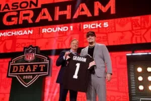 GREEN BAY, WISCONSIN - APRIL 24: Defensive Tackle Mason Graham of Michigan poses with NFL Commissioner Roger Goodell after being selected fifth overall pick by the Cleveland Browns during the first round of the 2025 NFL Draft at Lambeau Field on April 24, 2025 in Green Bay, Wisconsin.