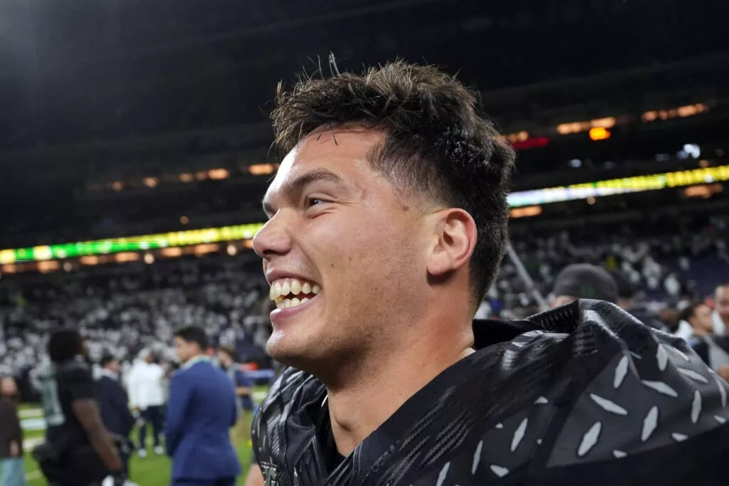 INDIANAPOLIS, INDIANA - DECEMBER 07: Dillon Gabriel #8 of the Oregon Ducks celebrates after the team's 45-37 win against the Penn State Nittany Lions in the 2024 Big Ten Football Championship at Lucas Oil Stadium on December 07, 2024 in Indianapolis, Indiana.