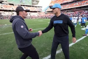 CLEVELAND, OHIO - NOVEMBER 03: Head coach Kevin Stefanski of the Cleveland Browns and head coach Jim Harbaugh of the Los Angeles Chargers shake hands after Los Angeles' 27-10 win at Huntington Bank Field on November 03, 2024 in Cleveland, Ohio.
