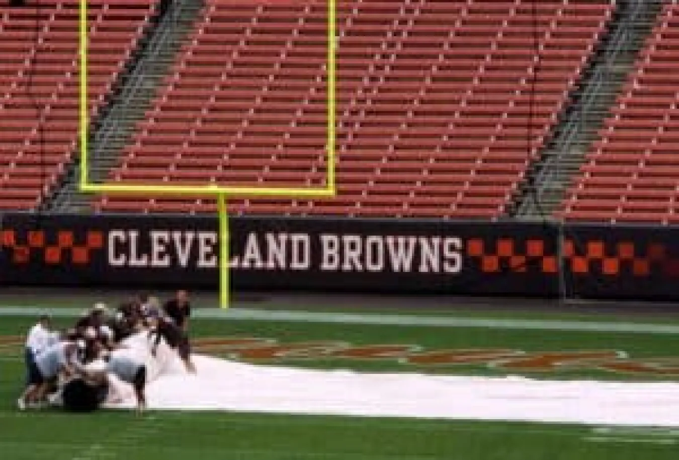 CLEVELAND - SEPTEMBER 09: Members of the groundcrew remove the tarps before the Cleveland Browns play the Pittsburgh Steelers in their season opening game at Cleveland Browns Stadium on Septmber 9, 2007 in Cleveland, Ohio.