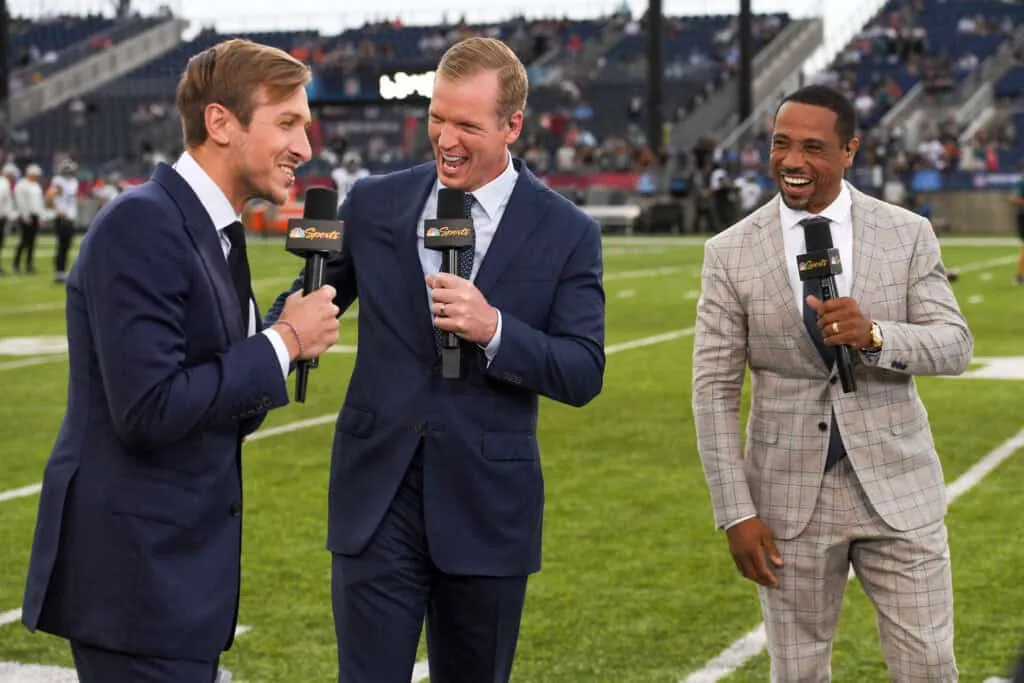 CANTON, OHIO - AUGUST 04: (L to R) NBC Sports commentators Jac Collinsworth, Chris Simms and Rodney Harrison laugh during a segment prior to the 2022 Pro Hall of Fame Game between the Jacksonville Jaguars and the Las Vegas Raiders at Tom Benson Hall of Fame Stadium on August 04, 2022 in Canton, Ohio.