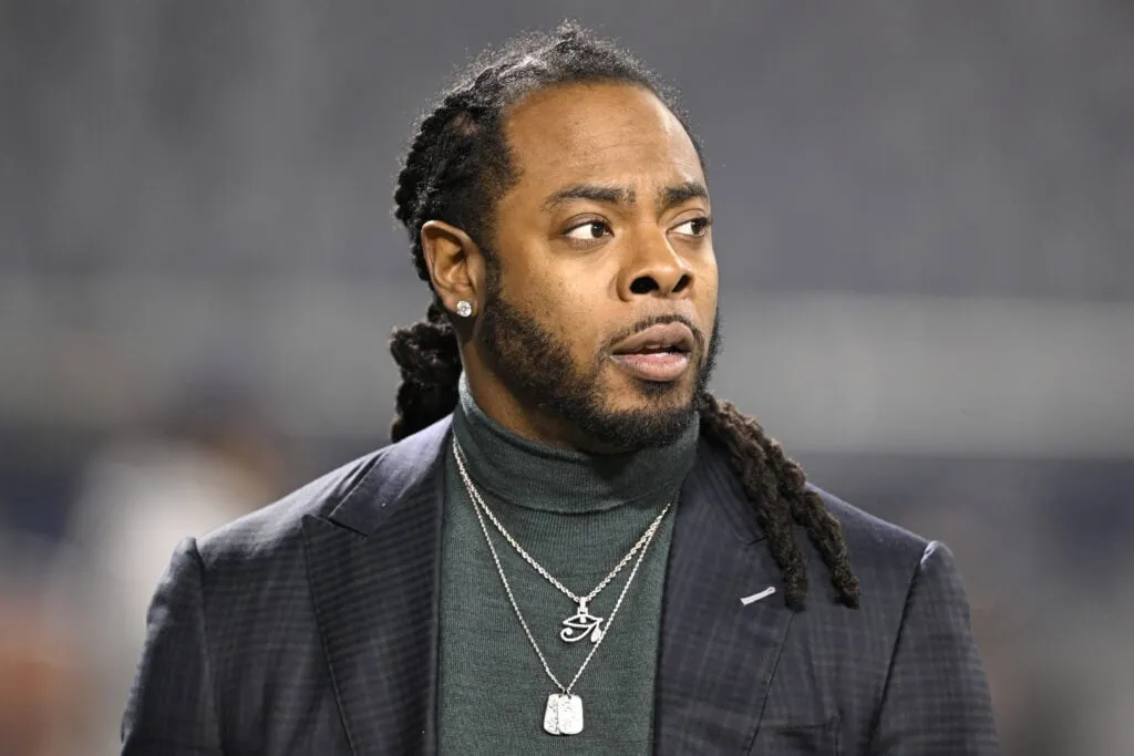 CHICAGO, ILLINOIS - DECEMBER 26: Richard Sherman looks on from the set of the TNF on Prime pregame show prior to the game between the Seattle Seahawks and the Chicago Bears at Soldier Field on December 26, 2024 in Chicago, Illinois.