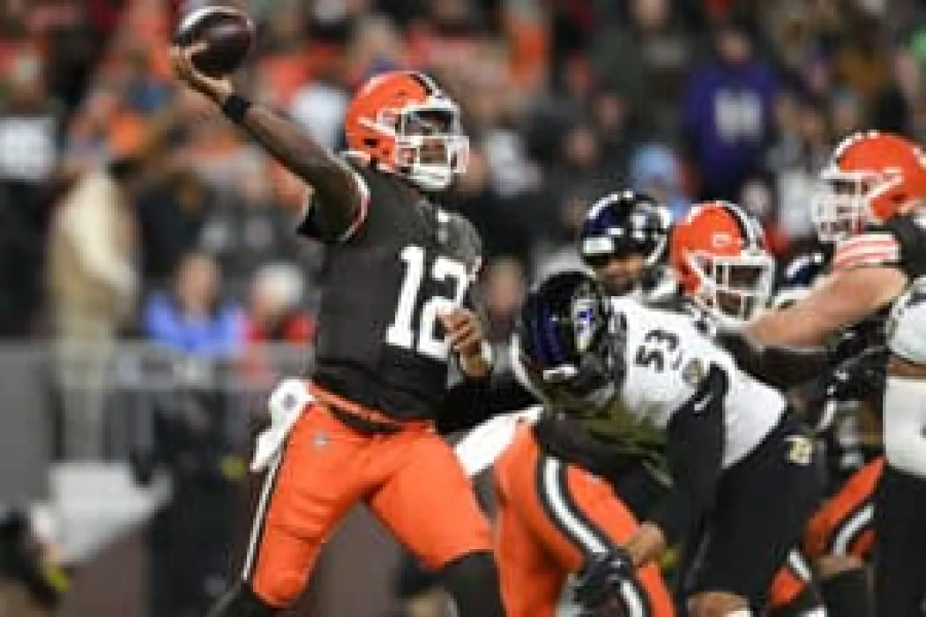 CLEVELAND, OHIO - NOVEMBER 16: Shedeur Sanders #12 of the Cleveland Browns makes a pass while under pressure against Kyle Van Noy #53 of the Baltimore Ravens in the game at Huntington Bank Field on November 16, 2025 in Cleveland, Ohio.