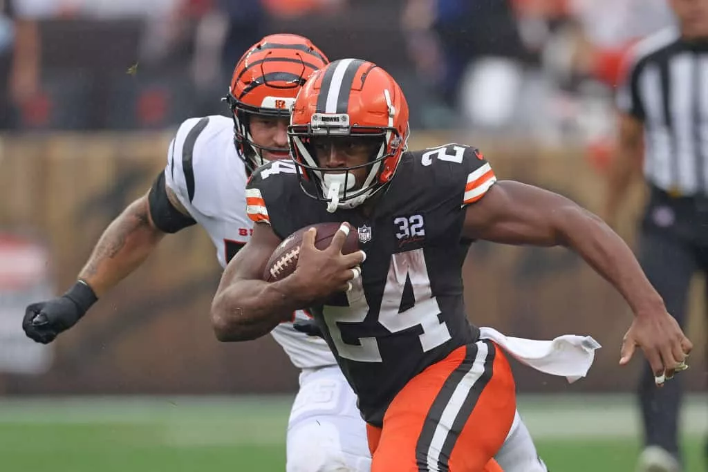 Nick Chubb #24 of the Cleveland Browns runs the ball against Logan Wilson #55 of the Cincinnati Bengals during the first half at Cleveland Browns Stadium on September 10, 2023 in Cleveland, Ohio.
