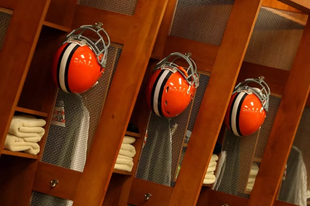 Cleveland Browns helmets hang in the Browns locker room at Cleveland Browns Stadium in Cleveland, Ohio.