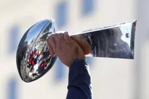 LOS ANGELES, CALIFORNIA - FEBRUARY 16: Andrew Whitworth #77 of the Los Angeles Rams raises the Vince Lombardi trophy during the Los Angeles Rams Super Bowl LVI victory parade on February 16, 2022 in Los Angeles, California.
