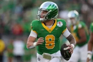 PASADENA, CALIFORNIA - JANUARY 01: Dillon Gabriel #8 of the Oregon Ducks scrambles with the ball during the Rose Bowl game against the Ohio State Buckeyes at Rose Bowl Stadium on January 01, 2025 in Pasadena, California.