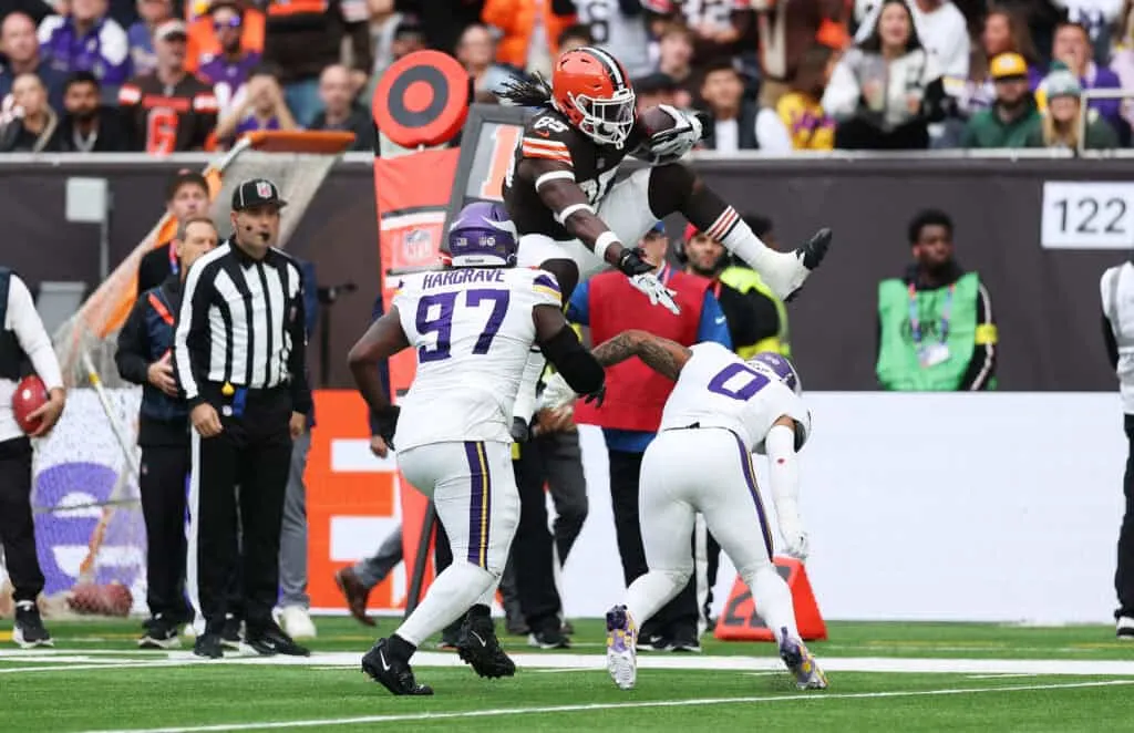 LONDON, ENGLAND - OCTOBER 05: David Njoku of Cleveland Browns hurdles Ivan Pace Jr. of Minnesota Vikings as he runs down field during the third quarter in the NFL 2025 game between Minnesota Vikings and Cleveland Browns at Tottenham Hotspur Stadium on October 05, 2025 in London, England.""