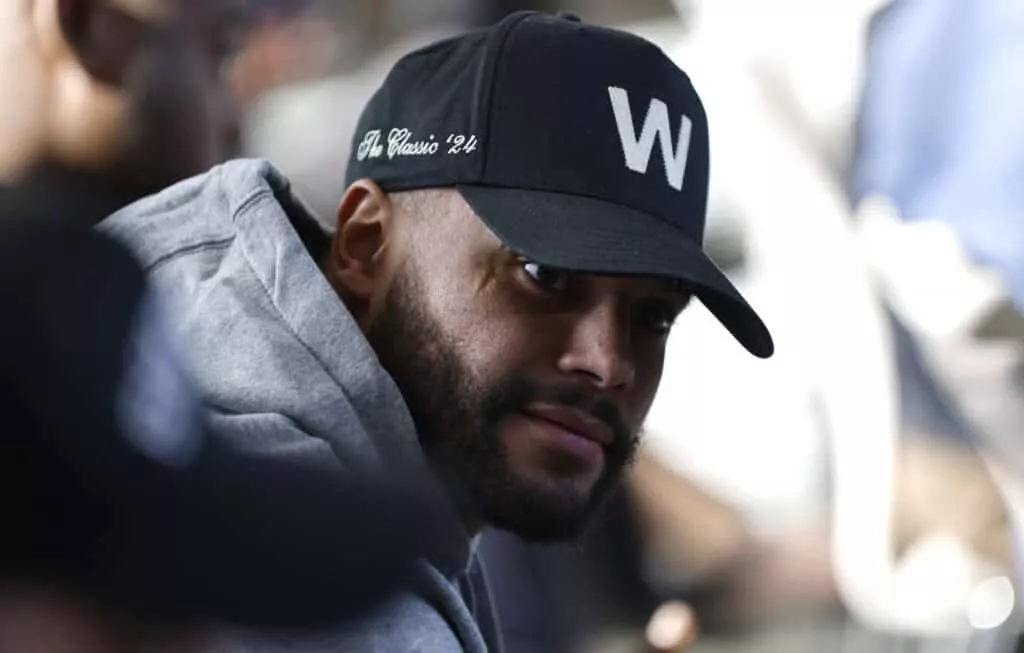 FRISCO, TEXAS - JANUARY 27: Dallas Cowboys quarterback Dak Prescott #4 looks on from the audience as Brian Schottenheimer is introduced as the new head coach of the Dallas Cowboys at The Star in Frisco on January 27, 2025 in Frisco, Texas.