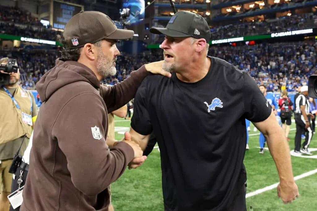DETROIT, MICHIGAN - SEPTEMBER 28: Head coach Kevin Stefanski of the Cleveland Browns and Head coach Dan Campbell of the Detroit Lions embrace after the game at Ford Field on September 28, 2025 in Detroit, Michigan.