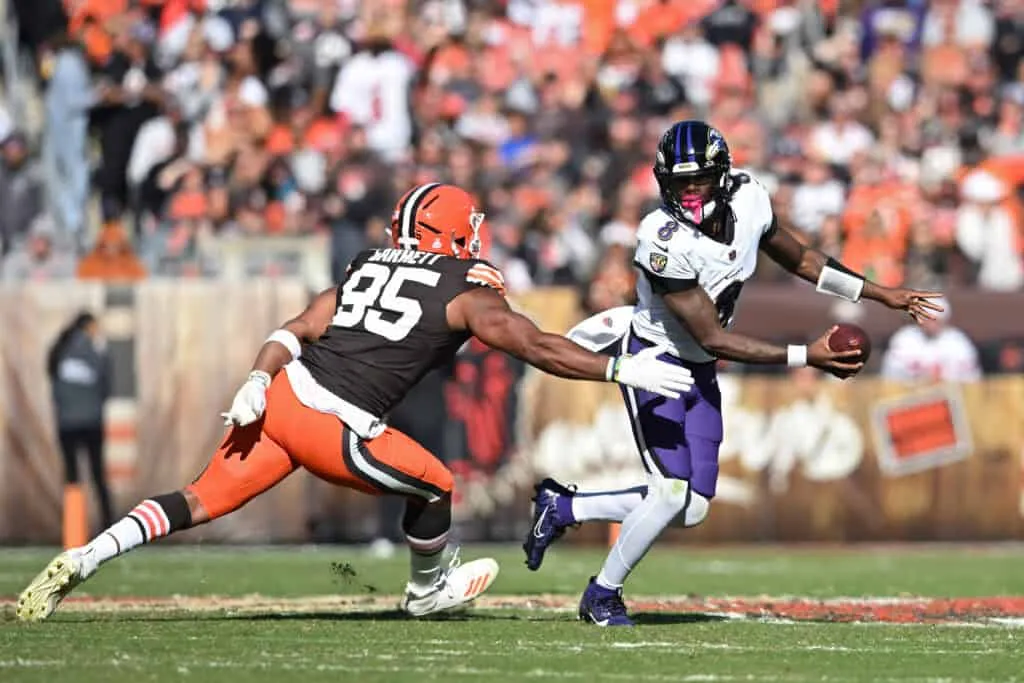 CLEVELAND, OHIO - OCTOBER 27: Myles Garrett #95 of the Cleveland Browns pressures Lamar Jackson #8 of the Baltimore Ravens in the third quarter of a game at Huntington Bank Field on October 27, 2024 in Cleveland, Ohio.