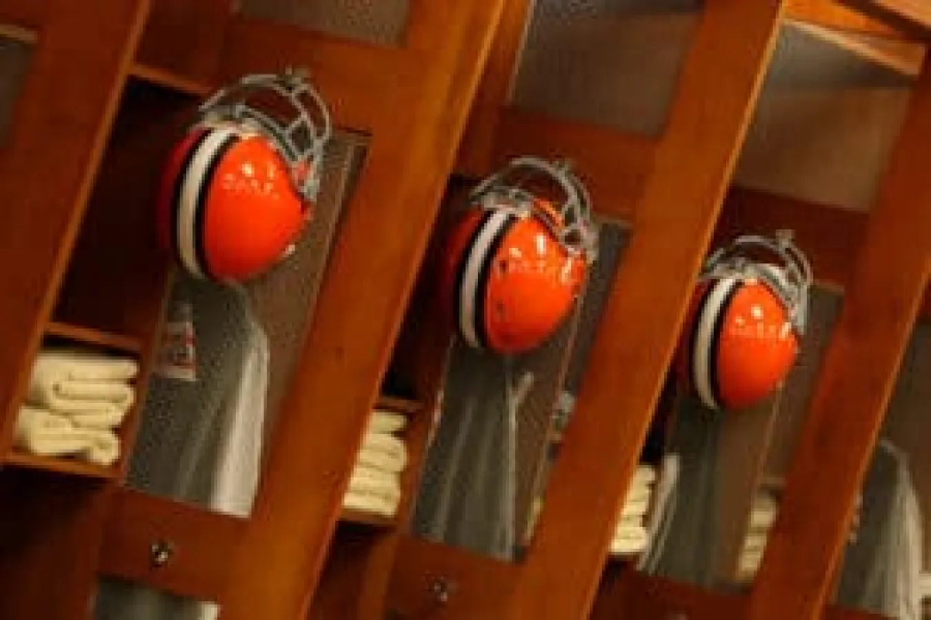 Cleveland Browns helmets hang in the Browns locker room at Cleveland Browns Stadium in Cleveland, Ohio.