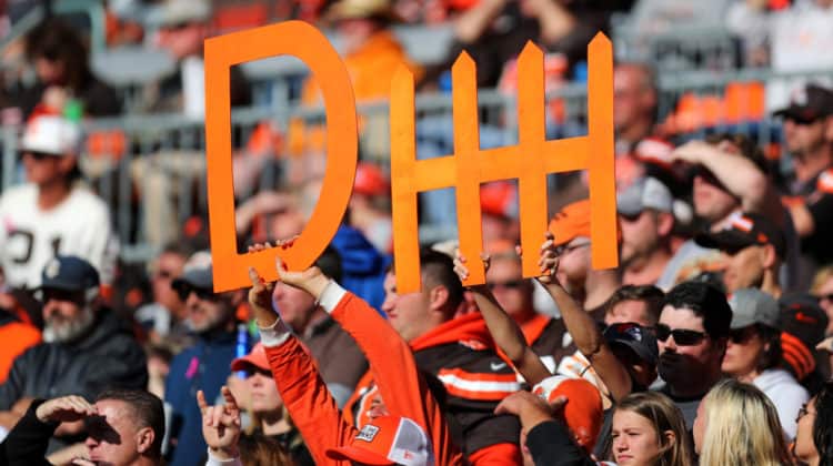 browns fans holding up a defense sign