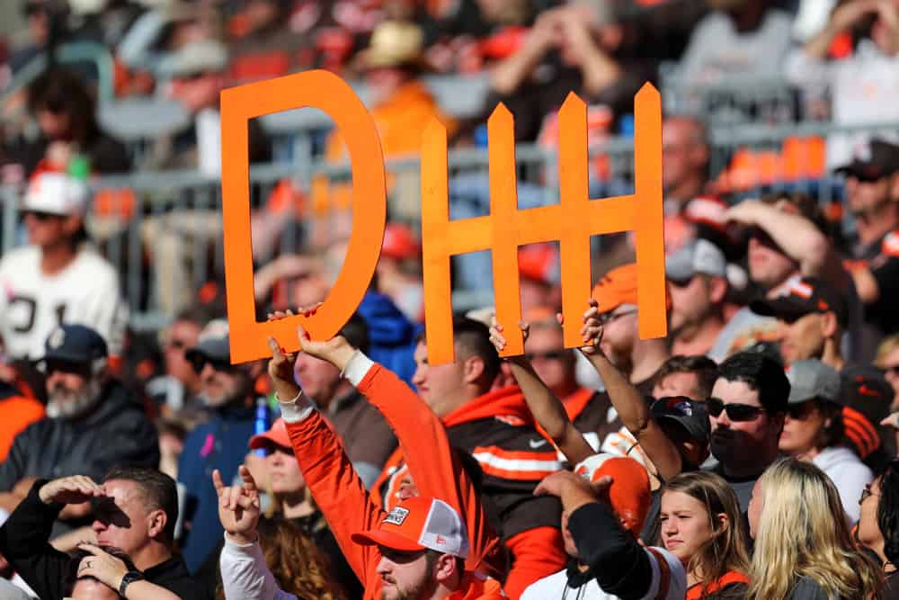 browns fans holding up a defense sign