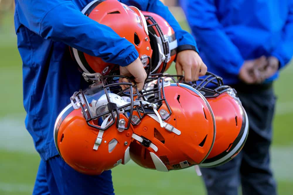 A Cleveland Browns equipment manager carries Browns helmets from the field following the National Football League game between the Seattle Seahawks and Cleveland Browns on October 13, 2019, at FirstEnergy Stadium in Cleveland, OH.