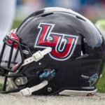 A Liberty Flames helmet on the turf during warmups prior to the game between the Liberty Flames and the West Virginia Mountaineers at Mountaineer Field at Milan Puskar Stadium in Morgantown, WV. West Virginia defeated Liberty 41-17.