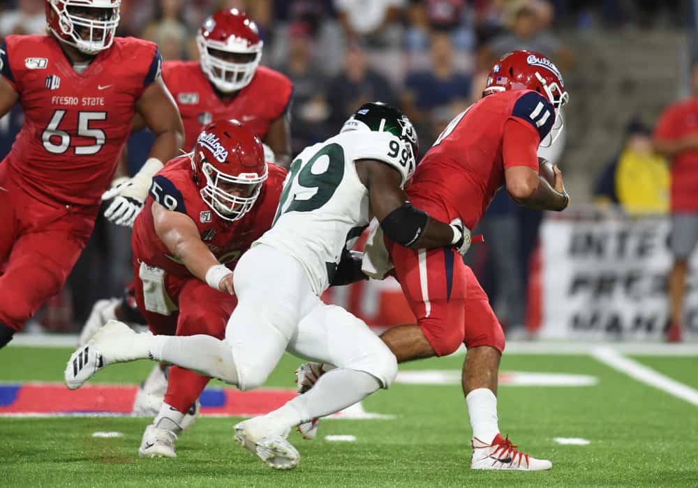 Sacramento State (99) George Obinna (DL) sacks Fresno State (11) Jorge Reyna (QB) during a college football game between the Sacramento State Hornets and the Fresno State Bulldogs on September 21, 2019, at Bulldog Stadium in Fresno, CA.