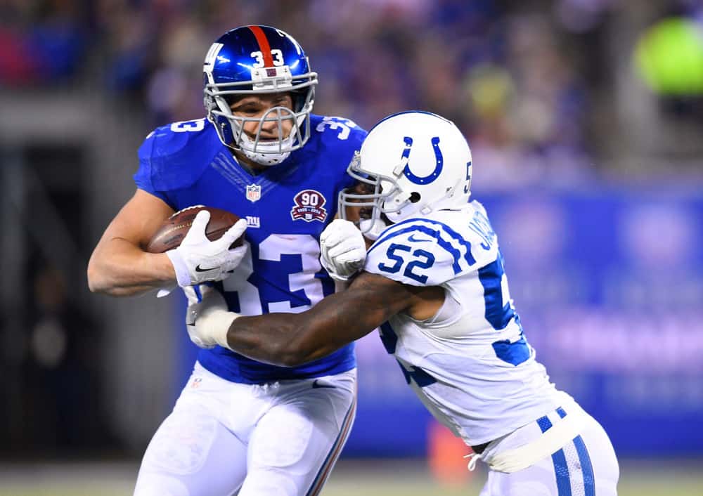 New York Giants running back Peyton Hillis (33) is chased by Indianapolis Colts inside linebacker D'Qwell Jackson (52) during a NFL game between the Indianapolis Colts and the New York Giants at MetLife Stadium in East Rutherford, NJ. The Colts defeated the Giants 40-24