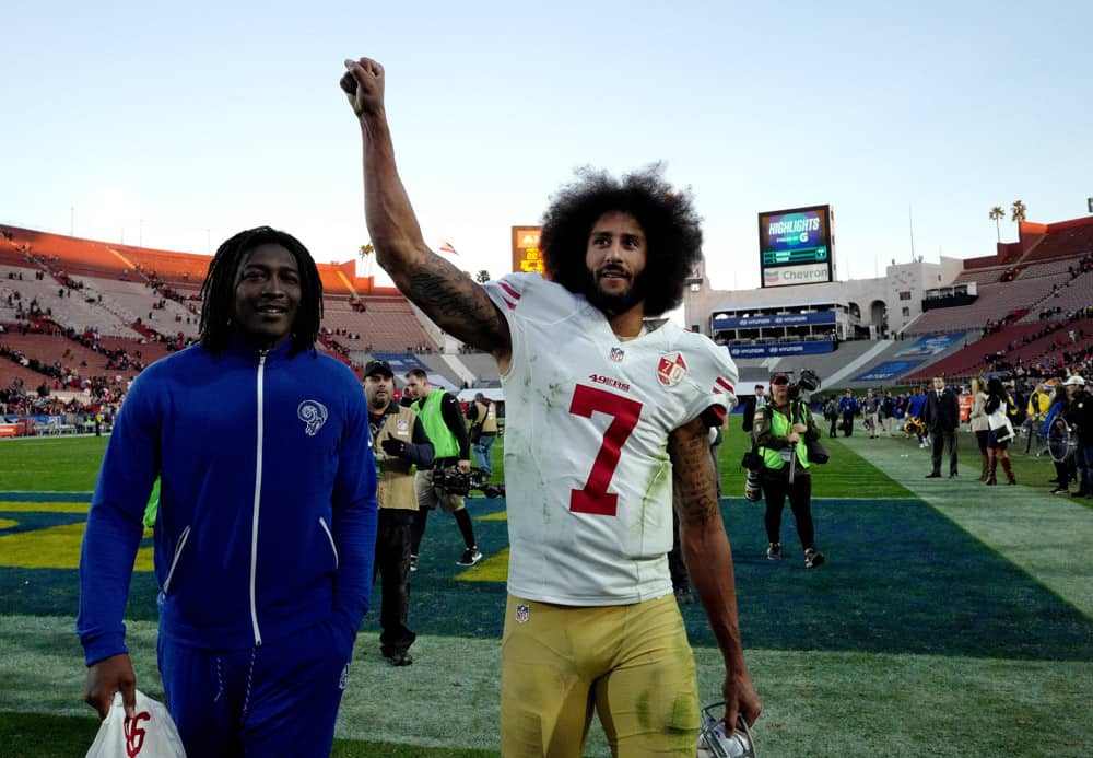 San Francisco 49ers quarterback Colin Kaepernick walks off the field holding up his fist as the San Francisco 49ers defeated the Los Angeles Rams 22-21 during a NFL football game at the Los Angeles Memorial Coliseum on Saturday, Dec. 24, 2016 in Los Angeles.