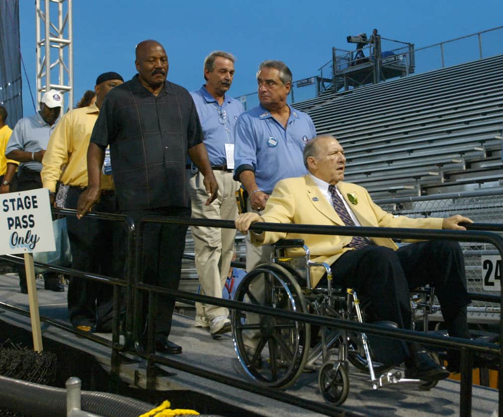 04 August 2007: Browns HOFer Gene Hickerson in wheel chair being led of the stage with Jim Brown following during induction ceremonies at the Pro Football Hall of Fame Field at Fawcett Stadium next door to the Pro Football Hall of Fame in Canton, Ohio.