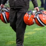 A Cleveland Browns equipment manager carries Cleveland Browns helmets following the National Football League game between the Cincinnati Bengals and Cleveland Browns on December 8, 2019, at FirstEnergy Stadium in Cleveland, OH.