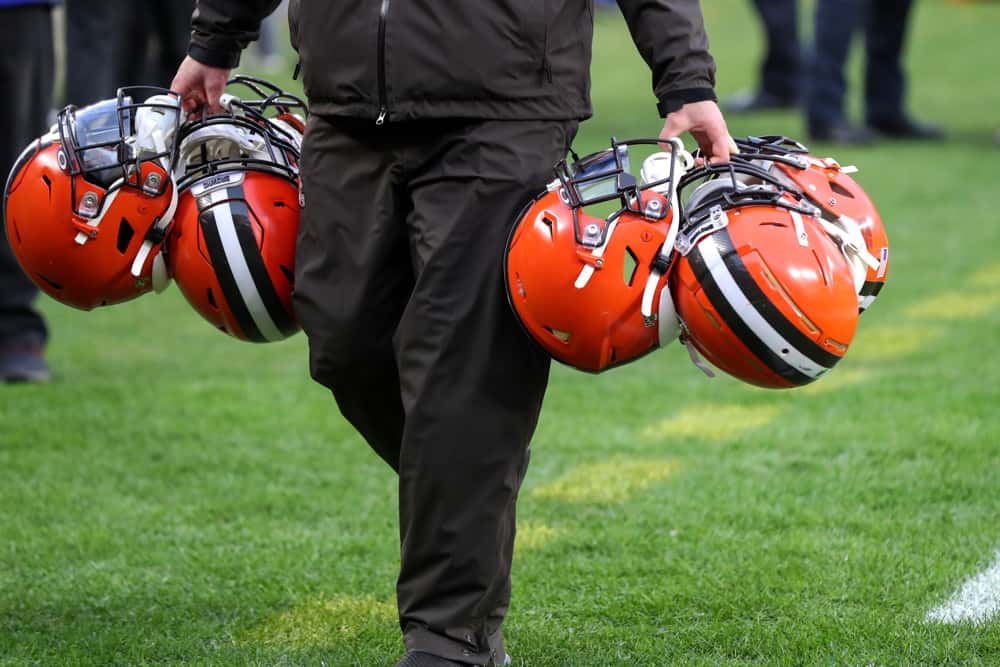 A Cleveland Browns equipment manager carries Cleveland Browns helmets following the National Football League game between the Cincinnati Bengals and Cleveland Browns on December 8, 2019, at FirstEnergy Stadium in Cleveland, OH.