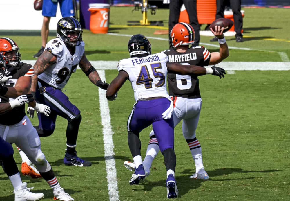 Cleveland Browns quarterback Baker Mayfield (6) is pressured by Baltimore Ravens linebacker Jaylon Ferguson (45) and defensive end Derek Wolfe (95) in the second half on September 13, 2020, at M&T Bank Stadium in Baltimore, MD.