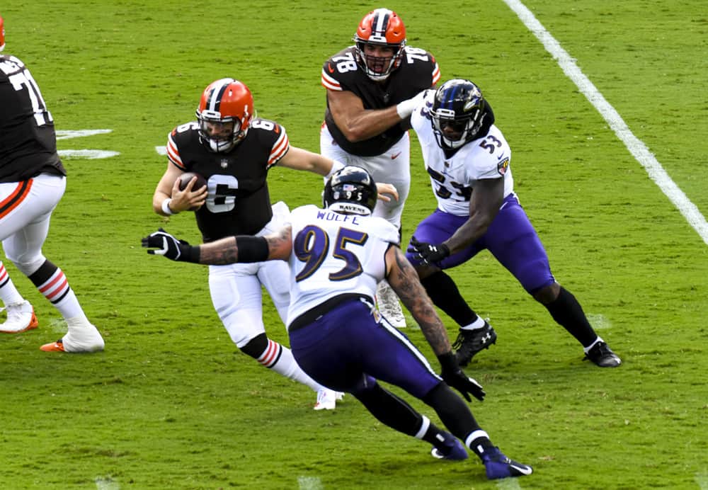 Cleveland Browns quarterback Baker Mayfield (6) scramble away from the pressure of Baltimore Ravens defensive end Derek Wolfe (95) and defensive end Jihad Ward (53) on September 13, 2020, at M&T Bank Stadium in Baltimore, MD. 