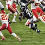 Baltimore Ravens running back J.K. Dobbins (27) runs against Kansas City Chiefs free safety Tedric Thompson (24) and cornerback Rashad Fenton (27) during the Kansas City Chiefs game versus the Baltimore Ravens on September 28, 2020 at M&T Bank Stadium in Baltimore, MD.