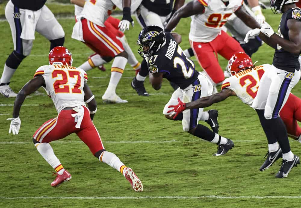 Baltimore Ravens running back J.K. Dobbins (27) runs against Kansas City Chiefs free safety Tedric Thompson (24) and cornerback Rashad Fenton (27) during the Kansas City Chiefs game versus the Baltimore Ravens on September 28, 2020 at M&T Bank Stadium in Baltimore, MD. 