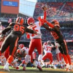 Kansas City Chiefs quarterback Patrick Mahomes (15) throws a pass out of his own end zone as Cleveland Browns defensive end Myles Garrett (95) and Cleveland Browns safety Jabrill Peppers (22) apply pressure during the first quarter of the National Football League game between the Kansas City Chiefs and Cleveland Browns on November 4, 2018, at FirstEnergy Stadium in Cleveland, OH.
