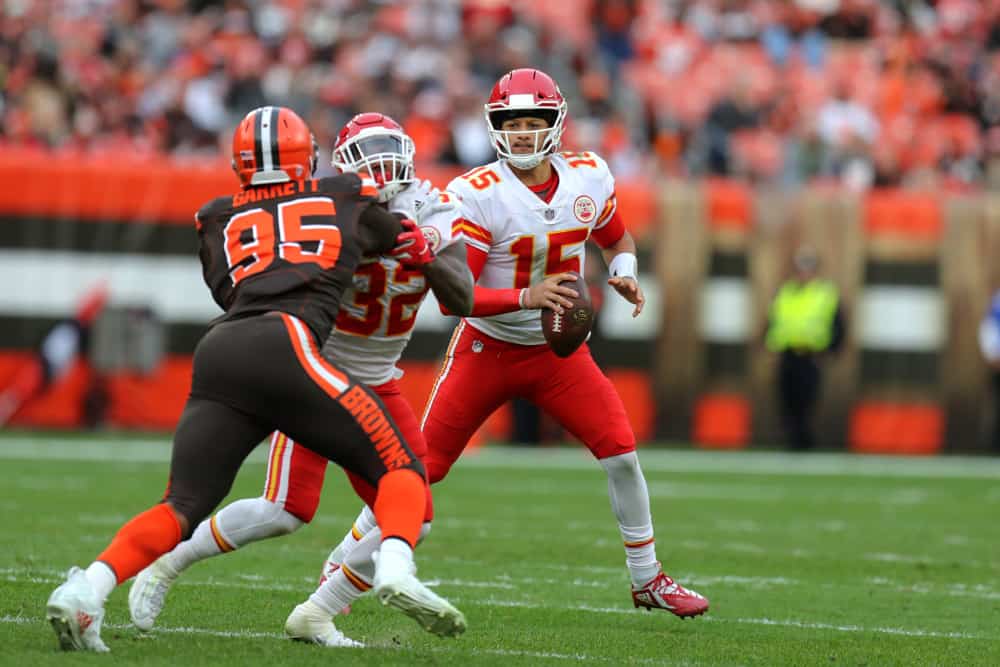 Kansas City Chiefs quarterback Patrick Mahomes (15) looks to pass as Kansas City Chiefs running back Spencer Ware (32) blocks Cleveland Browns defensive end Myles Garrett (95) during the fourth quarter of the National Football League game between the Kansas City Chiefs and Cleveland Browns on November 4, 2018, at FirstEnergy Stadium in Cleveland, OH. 