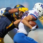 West Virginia Mountaineers linebacker Tony Fields II (1) makes a tackle on Kansas Jayhawks wide receiver Luke Grimm (80) during the first quarter of the college football game between the Kansas Jayhawks and the West Virginia Mountaineers on October 17, 2020, at Mountaineer Field at Milan Puskar Stadium in Morgantown, WV. Fields II was called for a horse collar tackle on the play.