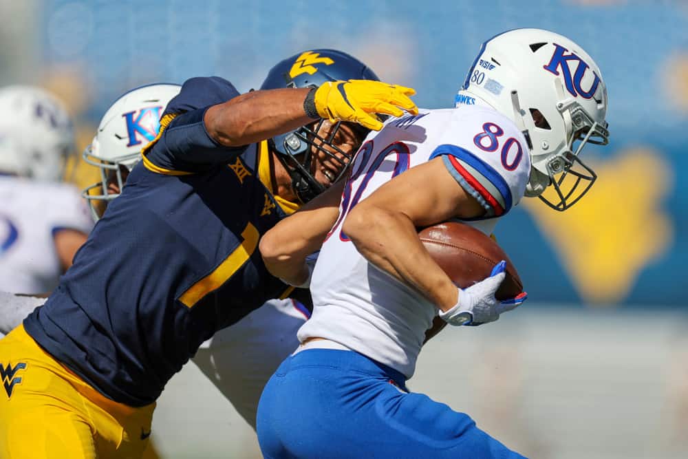 West Virginia Mountaineers linebacker Tony Fields II (1) makes a tackle on Kansas Jayhawks wide receiver Luke Grimm (80) during the first quarter of the college football game between the Kansas Jayhawks and the West Virginia Mountaineers on October 17, 2020, at Mountaineer Field at Milan Puskar Stadium in Morgantown, WV. Fields II was called for a horse collar tackle on the play.