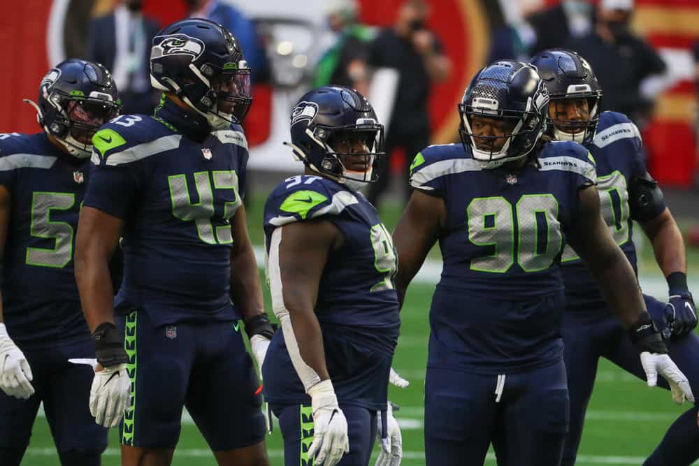 Seattle Seahawks Defensive End Carlos Dunlap (43), Nose Tackle Poona Ford (97), and Defensive Tackle Jarran Reed (90) during a game against the San Francisco at State Farm Stadium on January 3, 2021 in Glendale, Arizona.