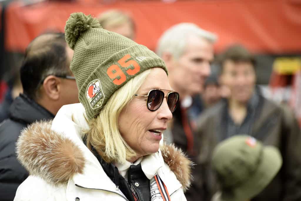 Team owner Dee Haslam of the Cleveland Browns talks with guests on the sidelines while wearing a hat supporting defensive end Myles Garrett #95 prior to the game against the Miami Dolphins at FirstEnergy Stadium on November 24, 2019 in Cleveland, Ohio.