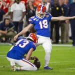 Florida Gators punter Tommy Townsend (43) holds the ball as Florida Gators kicker Evan McPherson (19) kicks for an extra point during the College Football game between the Florida Gators and the Virginia Cavaliers at the Capital One Orange Bowl on December 30, 2019 at the Hard Rock Stadium in Miami Gardens, FL.