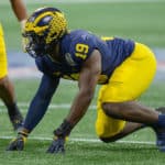 Michigan's Kwity Paye (19) prepares to rush the quarterback during the Chick-fil-A Peach Bowl between the Michigan Wolverines and the Florida Gators on December 29th, 2018 at Mercedes-Benz Stadium in Atlanta, GA.