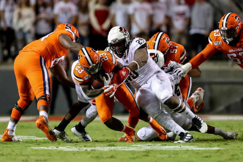 Syracuse Orange running back Abdul Adams (23) is tackled by North Carolina State Wolfpack defensive tackle Alim McNeill (29) during a college football game between the North Carolina State Wolfpack and the Syracuse Orange on October 10, 2019 at Carter-Finlay Stadium in Raleigh, NC. 