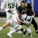 Wake Forest Demon Deacons defensive lineman Carlos Basham Jr. (9) takes down Michigan State Spartans quarterback Brian Lewerke (14) down for a sack during the 2019 Pinstripe Bowl between the Michigan State Spartans and the Wake Forest Demon Deacons on December 27, 2019, at Yankee Stadium in New York, NY.