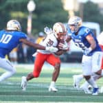Oklahoma State Cowboys RB Chuba Hubbard (30) runs through the tackle attempt by Tulsa Golden Hurricane S Manny Bunch (10) and Tulsa Golden Hurricane LB Zaven Collins (23) during a college football game between the Tulsa Golden Hurricane and the Oklahoma State Cowboys on September 14, 2019, at H.A. Chapman Stadium in Tulsa, OK.