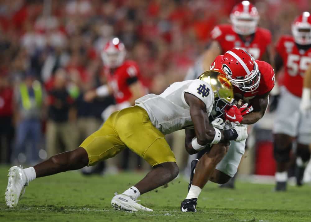 Georgia Bulldogs running back Brian Herrien (35) is tackled by Notre Dame Fighting Irish linebacker Jeremiah Owusu-Koramoah (6) during the second half of the Notre Dame Fighting Irish v Georgia Bulldogs game on September 21, 2019 at Sanford Stadium in Athens, GA.