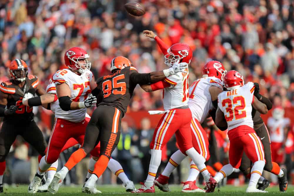 Kansas City Chiefs quarterback Patrick Mahomes (15) is hit by Cleveland Browns defensive end Myles Garrett (95) as he throws a pass during the second quarter of the National Football League game between the Kansas City Chiefs and Cleveland Browns on November 4, 2018, at FirstEnergy Stadium in Cleveland, OH. 