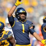 West Virginia Mountaineers linebacker Tony Fields II (1) celebrates after making a tackle on Kansas Jayhawks wide receiver Luke Grimm (80) during the first quarter of the college football game between the Kansas Jayhawks and the West Virginia Mountaineers on October 17, 2020, at Mountaineer Field at Milan Puskar Stadium in Morgantown, WV. Fields II was called for a horse collar tackle on the play.